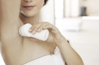 Woman applying deodorant Woman applying deodorant