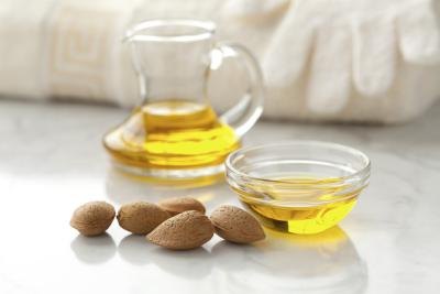 A small bowl of almond oil. A small bowl of almond oil.