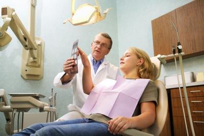 Dentist having discussion with patient. Dentist having discussion with patient.