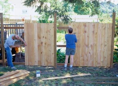 Family building a backyard fence Family building a backyard fence