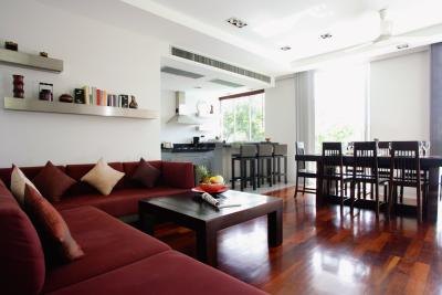 An open floor plan of a living room, dining room, and kitchen. An open floor plan of a living room, dining room, and kitchen.