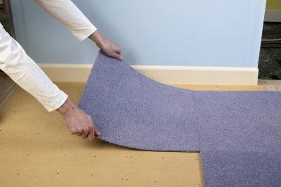 A man installs carpet A man installs carpet