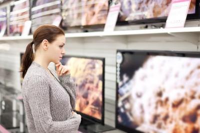Woman shopping for wide screen television Woman shopping for wide screen television