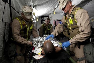 Navy corpsmen perform a training drill. Navy corpsmen perform a training drill.