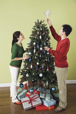 Couple decorating Christmas tree Couple decorating Christmas tree