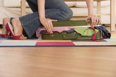 woman packing suitcase for trip woman packing suitcase for trip