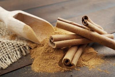 Close up of cinnamon sticks and ground cinnamon Close up of cinnamon sticks and ground cinnamon