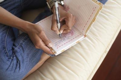 Woman writing in journal Woman writing in journal