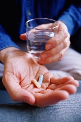 Man taking vitamins Man taking vitamins