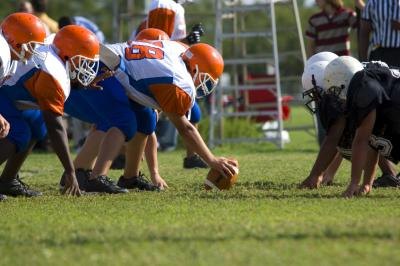 Football players on the line of scrimmage Football players on the line of scrimmage
