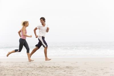 Couple jog on beach Couple jog on beach