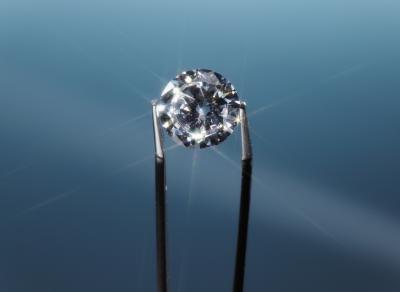 Tweezers holding diamond. Tweezers holding diamond.
