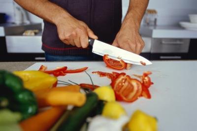 Man cutting red peppers Man cutting red peppers