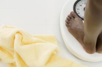 Woman's feet on bathroom scale Woman's feet on bathroom scale