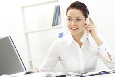 Secretary answering phone at front desk Secretary answering phone at front desk