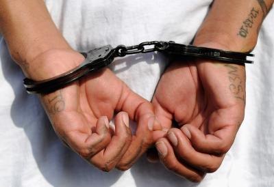 Gang member in handcuffs Gang member in handcuffs