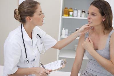doctor feeling woman's thyroids doctor feeling woman's thyroids