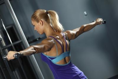 A woman is exercising her shoulders. A woman is exercising her shoulders.