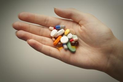 Assorted pills in an open hand. Assorted pills in an open hand.