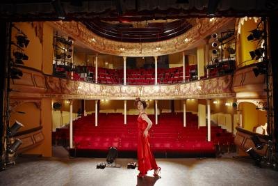 Actor on stage in a theatre. Actor on stage in a theatre.