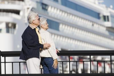 A woman leans into a man on a pier. A woman leans into a man on a pier.