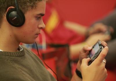 Young man with his PlayStation Portable Young man with his PlayStation Portable