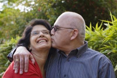 Elderly husband kissing his wife on the cheek. Elderly husband kissing his wife on the cheek.