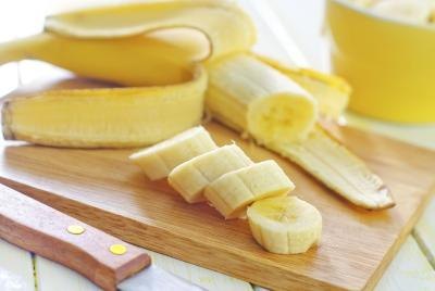 Sliced banana on cutting board Sliced banana on cutting board