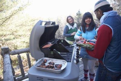 Friends having a winter barbeque. Friends having a winter barbeque.
