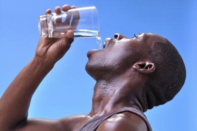 Dehydrated young man drinking water. Dehydrated young man drinking water.