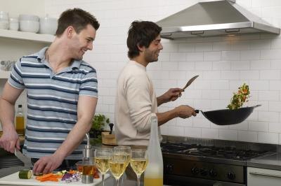 Two men cooking in the kitchen. Two men cooking in the kitchen.