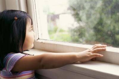 Young girl looking out window. Young girl looking out window.