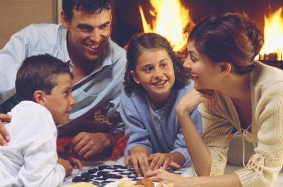 Family playing board game together. Family playing board game together.