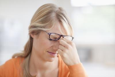 woman with headache and eye pain woman with headache and eye pain