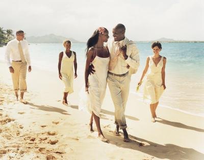 Newlyweds walking on beach Newlyweds walking on beach