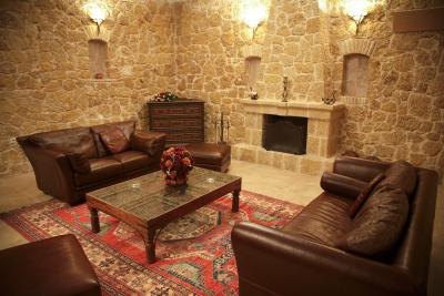 A basement living room, with leather sofas, a table, atop an Oriental carpet. A basement living room, with leather sofas, a table, atop an Oriental carpet.