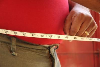 man measuring stomach circumference man measuring stomach circumference