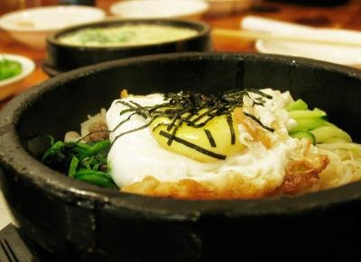 Bibimbap continues to cook at the table, in its traditional stone pot. Bibimbap continues to cook at the table, in its traditional stone pot.