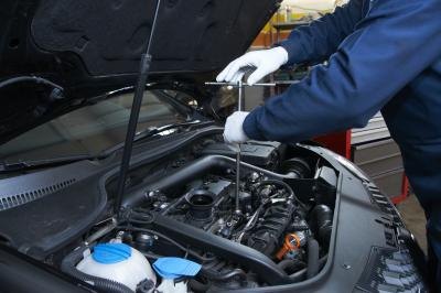 Mechanic working on engine of car