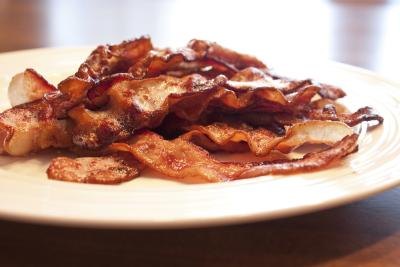 Saturated fat in foods like bacon raises bad cholesterol levels. Saturated fat in foods like bacon raises bad cholesterol levels.