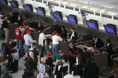 Airline customers at airport ticket counter