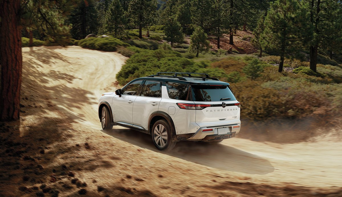 nissan car driving down dirt road