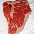 Dry aged raw beef steak with ingredients for grilling