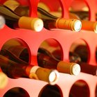 close-up of a glass of wine in front of an array of bottles