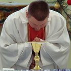 priest baptizing a baby boy