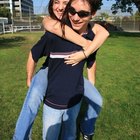 France, Paris, young couple outdoors, man holding flowers behind back