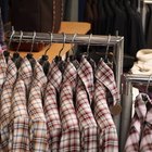 Man browsing through rack of shirts