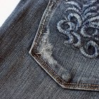 Woman's rear end sitting on barstool in jeans, Curacao