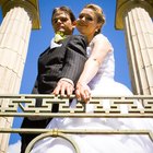 Bride with the groom sitting on a pier