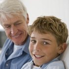 Close-up of a mature couple looking at photographs with their teenage son